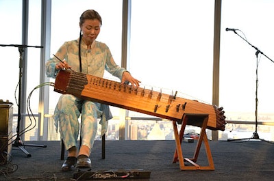 On one of the stages, a musician strummed an electric komungo, a traditional Korean instrument.