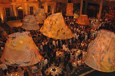 For dinner in the Engelhard Court, Avila and de Chatillon channeled Poiret's world of theater, using fabrics and wall coverings that incorporated patterns designed by Poiret. Rosebushes and fabric-covered ottomans divided the open space into smaller, more intimate areas.