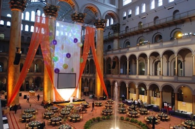 Hargrove Inc. draped 80- to 100-foot-tall swathsof sheer tangerine fabric from the ceiling to the stage.