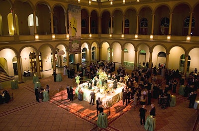 The cocktail hour featured a spotlightedfour-sided bar among highboys draped in dark green cloths.