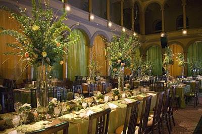 Five-foot-tall centerpieces, crowned with whitetulips, green and orange roses, yellow forsythia, chartreuse spider mums, andcopious greenery, towered over the tables.