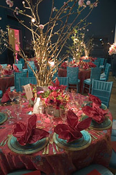 Bright turquoise silk organza chair covers withturquoise beads, manufactured by Perfect Settings, stood out next to acherry-blossom centerpiece, silk hand-painted tablecloths, and fuchsia silknapkins folded to look like birds.