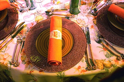 The tiki room featured paper cigar bands asnapkin holders, a chocolate cigar at each place setting, and floralcenterpieces with pineapples, lemons, limes, hypericum berries, and assortedproteas.