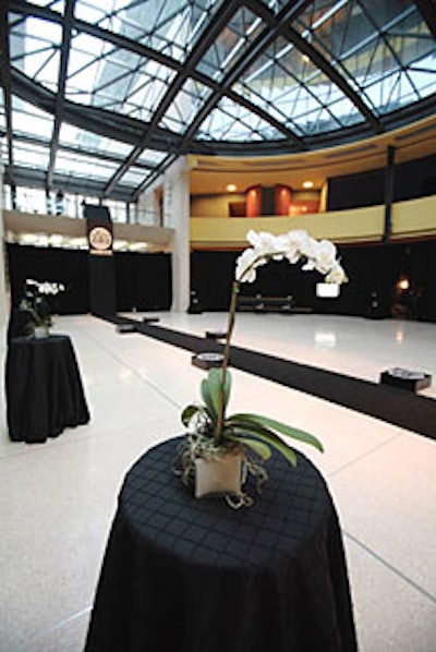 Blacksilk pintuck tablecloths topped with white orchids fit the party’sblack-and-white theme. The food also matched, as did the drinks: whitechocolate martinis and a Level vodka and Ocean Spray whitecranberry cosmo called “the Donatella.”