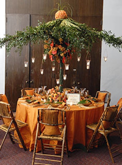 Catering by Windows’ John Dunne designed the“Sunset Soiree” table, which featured an umbrella of orchids, ivy, and vineshanging over the table’s tangerine linens and amber china.