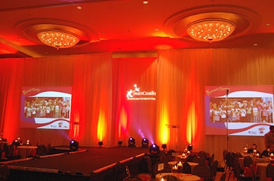 Hot pink, orange, and purple lighting, cream-colored drapes, a fog machine, and techno music created a high-energy atmosphere.