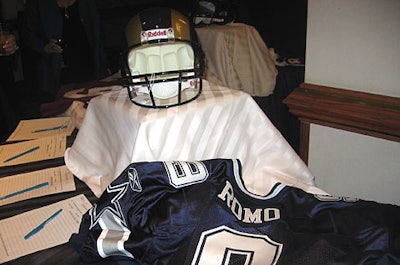 The bidding started at $350 for a TonyRomo-autographed replica jersey, one of many sports items up for auction.Guests could also bid on less macho items, like a Marc Jacobs purse, vacationpackages, and jewelry.