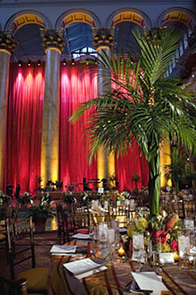 Jack H. Lucky Floral Design created the five-foot-tall centerpieces, which featured areca palm tops draped with date palms and accented by mokara orchids, baby pineapples, roses, hypericum berries, safari sunset flowers, and peach calla lilies.