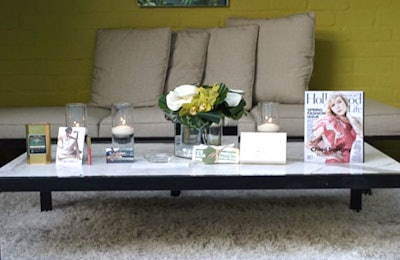 Floating pillar candles and small arrangementsof hydrangeas and orchids topped simple tables.