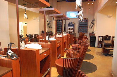 A flat-screen TV hangs above the salon's styling stations.