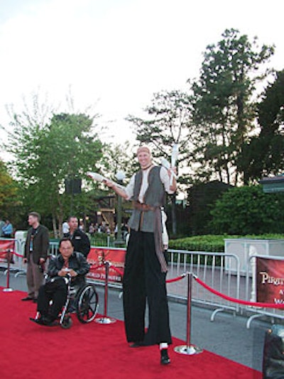 A towering stiltwalker entertained toward the end of the carpet, where the crowd finally thinned.