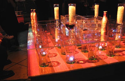 Soda glasses from sponsor Coca-Cola served as building blocks beneath glass-top coffee tables.