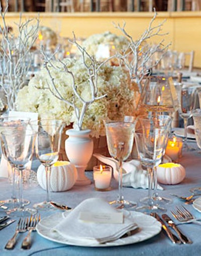 White accents included white bisque seashells, faux white coral, and arrangements of white carnations in country baskets on dining tables.