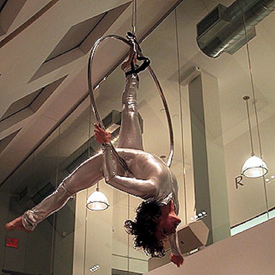 Anna Jack of Chez-zam performed on a silver ring suspended above the crowd, adding a carnivalesque element to the Accessories Council's March in Monaco event.