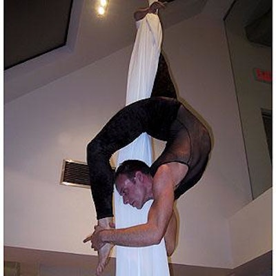 Fabric aerialist Jonathan Nosan of Chez-zam performed on a piece of cloth suspended from the ceiling.