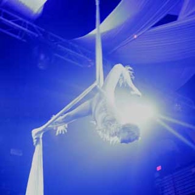 An angelic aerialist from CircX twisted and spun in the air during a performance about the struggle between good and evil.