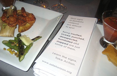 Cards at each place setting reminded guests that domestic violence isoften hard to spot, and urged them to take action against it.