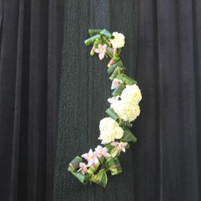 Curtains adorned by florals framed the path up the stairs to the event space.