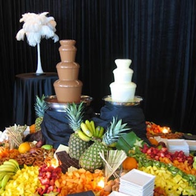 A table of fresh fruit stood next to a pair of chocolate fountains.