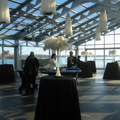 Las Vegas-style white feathery decor topped black-clad cocktail tables.