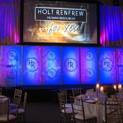 The stage from Stagevision had a clear plastic backdrop and a massive screen that displayed the Holt Renfrew name in pink, blue, and purple colours that constantly changed.