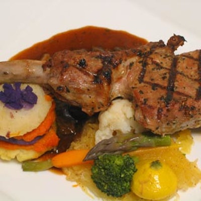 Gourmet Cuisine served a veal chop with potatoes and vegetables in a four mushroom ragout.