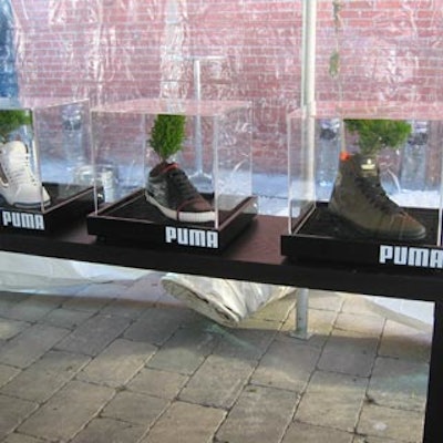 In a tent outside the building, Puma filled display cases with shoes sprouting green plants.