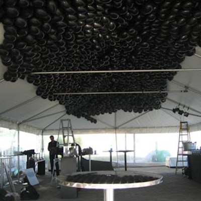 Black balloons covered the ceiling of the white Puma tent.