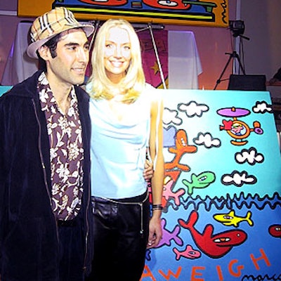 Artist Marco and special guest Miss USA 2001 Kandace Krueger posed in front of the bright, nautical-themed official logo for the Muscular Dystrophy Association's Anchors Aweigh 2001.