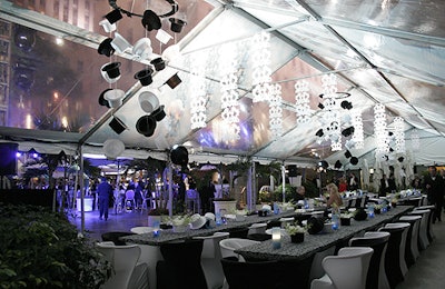 An open tent welcomed guests to communal tables and a mobile of top hats and filigree. Producers used the furniture on hand at Rockefeller Center instead of bringing in rentals.