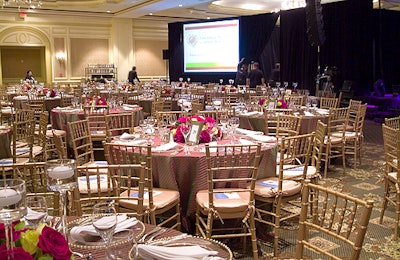 The gold and olive table linens coordinated with the ballroom's pale gold silk wall coverings.