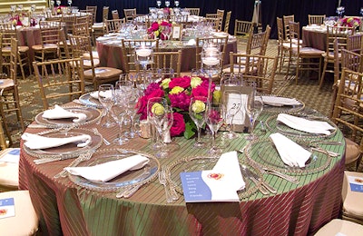 The 60 tables each had centerpieces by Exquisite Design Studio, made of red, white, and lavender rose-filled bowls.