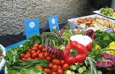 Signage identified offerings from brands such as Trois Petit Cochon pâté, President cheeses, and Barnier olives wherever they appeared.