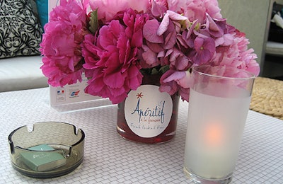 Romantic arrangements of hydrangeas and peonies adorned cocktail tables.