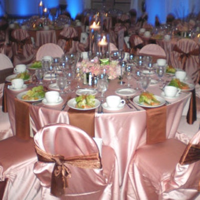 Sheer organza chair ties from Cloth Connection added sparkle to the pink champagne and copper linens from BBJ Linen-Orlando.
