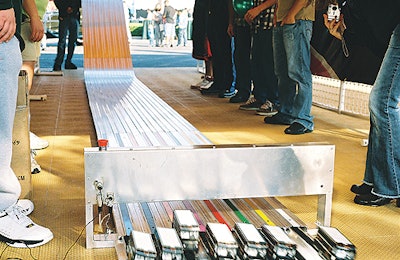 Kids can race mini UPS trucks on a 30-foot ramp.