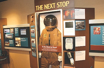 A space suit with the UPS logo, positioned at the end of the exhibit, is a suggestion of things to come.