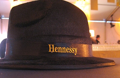 Servers wore Hennessy-branded fedoras.