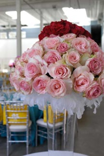 Thick bouquets of pink and red roses topped centrepieces without feathers and fishnets.