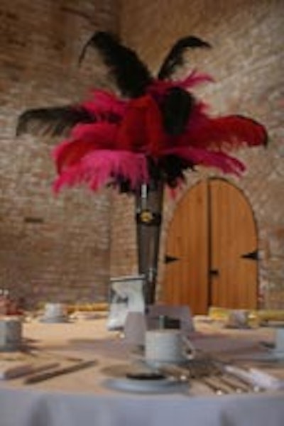 Some dining spaces got a heavier looking design with strictly feathers and sheer black fabric covered vases for centrepieces.