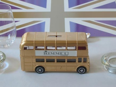 Gold-coloured, double-decker busses bearing the Rimmel name adorned the dinner tables.