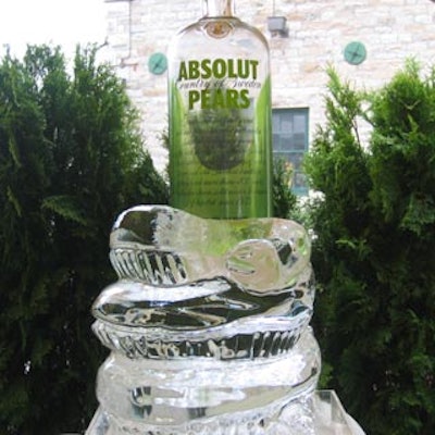A coiled snake ice sculpture from Iceculture supported a massive bottle of Absolut Pears.