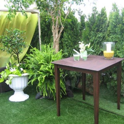 Green and cream coloured candles and small floral arrangements accented brown cocktail tables.