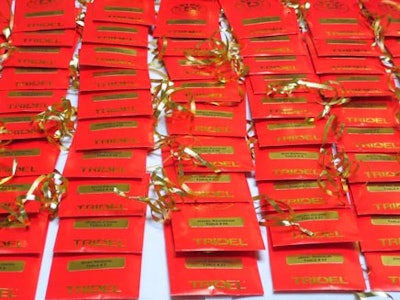 Guests received traditional Chinese red envelopes—signifying good fortune and prosperity—with their table assignments inside.