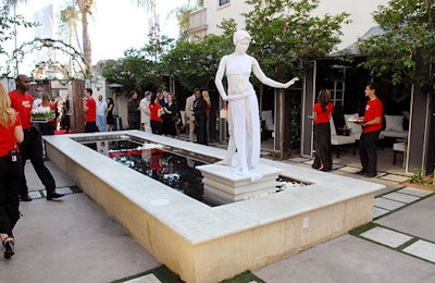 Dancers set to look like classical Greek statues stood atop pedestals in Boulevard3's reflection pool.