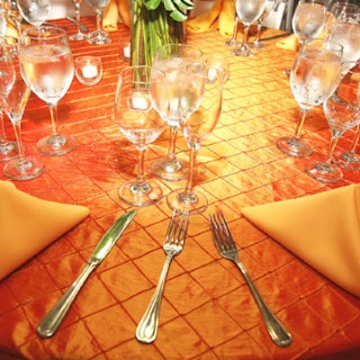 SoireeEvent Rentals provided iridescent linens in deep orange, reflecting a tropicalhue.