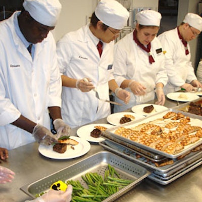 Studentsworked together to present a menu of both grilled salmon and filet mignon.