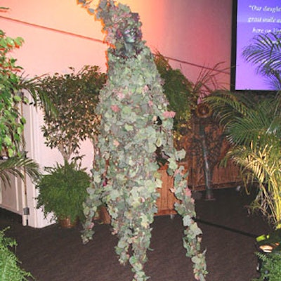 A Busch Gardens wandering vine-themed stiltwalkerblended perfectly with the background foliage.