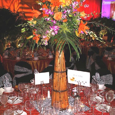 Bamboo reed cones were filled with exotic flowers andgreenery, such as orange calla lilies, dendrobium orchids, and palm leaves, tocreate lavish centerpieces.