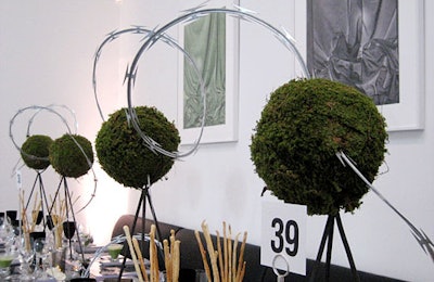 The smoke-gray dinner room employed topiaries connected by barbed wire as centerpieces.